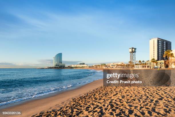 barcelona with blue sky at sunrise. seafront, beach,coast in spain. suburb of barcelona, catalonia - barceloneta fotografías e imágenes de stock