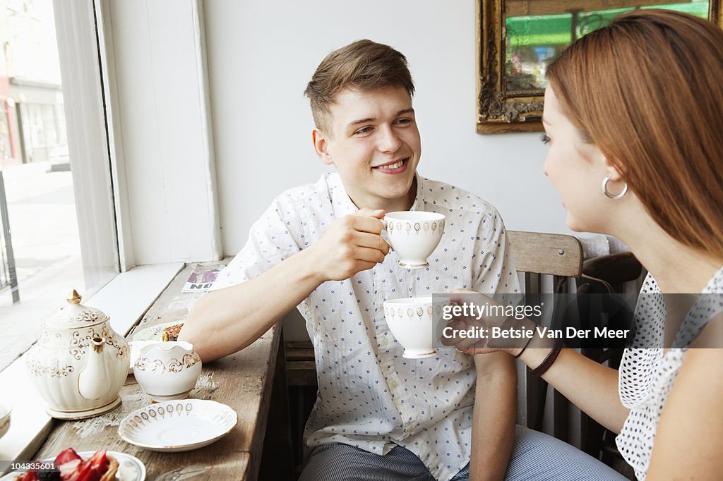 Couple drinking tea in cafe.