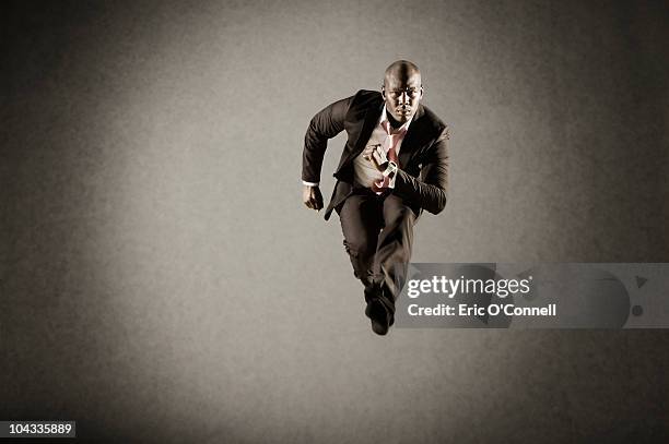 african american make hurtling in suit - sprinting suit stock pictures, royalty-free photos & images