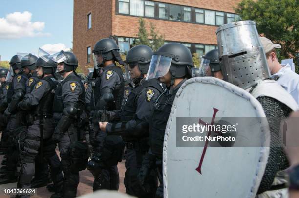 Man dressed as a Crusades knight stands with police during an open carry rally at Kent State University in Kent, Ohio on September 29, 2018.