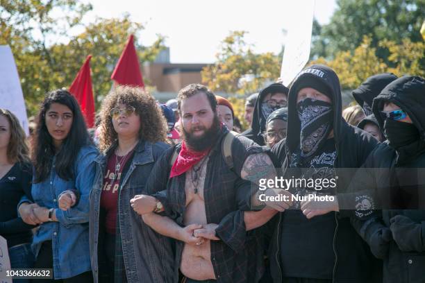 Protesters lock arms during an open carry rally at Kent State University in Kent, Ohio on September 29, 2018.