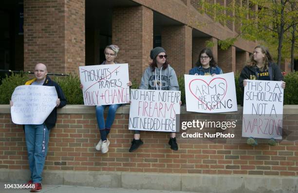 Students hold signs during an open carry rally at Kent State University in Kent, Ohio on September 29, 2018.