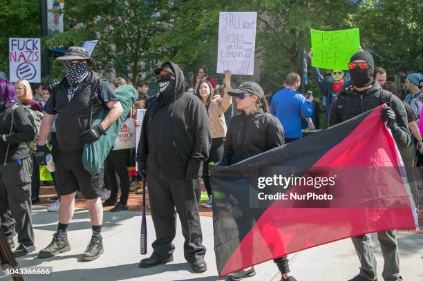 Protesters hold flags and signs during an open carry rally at Kent State University in Kent, Ohio on September 29, 2018.