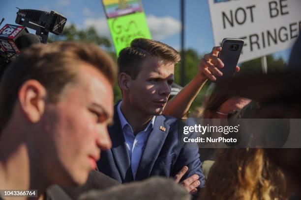 Ryan Fournier, Chairman of Students for Trump, listens to Kaitlin Bennett debate counter protesters. Kaitlin Bennett, a former student of Kent State...