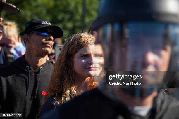 Kaitlin Bennett, a a squad of Three Precenter Milita members and a wall of riot police, tried to debate counter protesters.Kaitlin Bennett, a former...