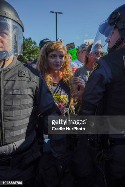 Kaitlin Bennett, a a squad of Three Precenter Milita members and a wall of police, tried to debate counter protesters.Kaitlin Bennett, a former...