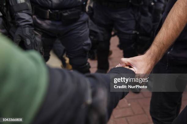 Protesters link hands after a protester was arrested by Ohio State Police.Kaitlin Bennett, a former student of Kent State University, lead an open...