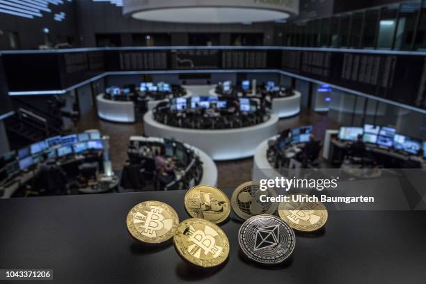 Symbol photo on the topics digital curreny, cryptocurrency, currency speculation, stock market, etc. The picture shows Bitcoin, Ripple, Litecoin and...