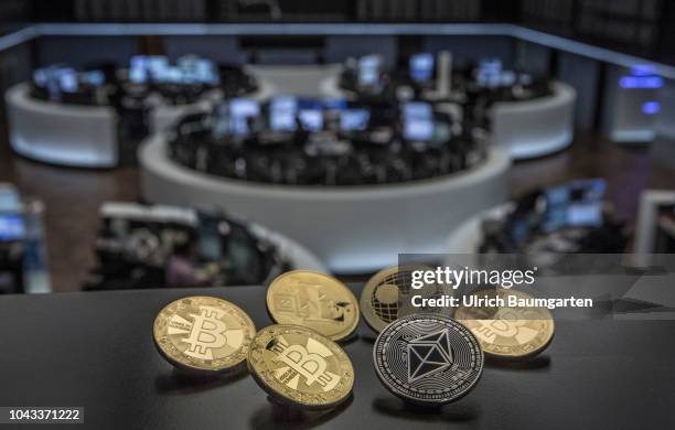 Symbol photo on the topics digital curreny, cryptocurrency, currency speculation, stock market, etc. The picture shows Bitcoin, Ripple, Litecoin and...