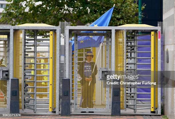 An anti-brexit demonstrator stands at the security gates outside the annual Conservative Party Conference on September 30, 2018 in Birmingham,...