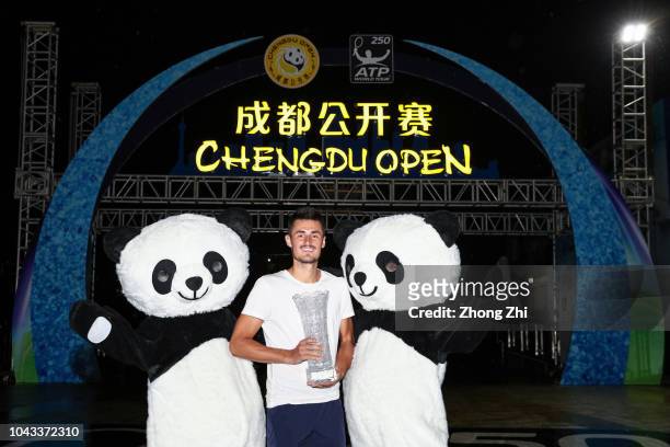 Bernard Tomic of Australia celebrates with trophy after winning his final match against Fabio Fognini of Italy during 2018 ATP World Tour Chengdu...