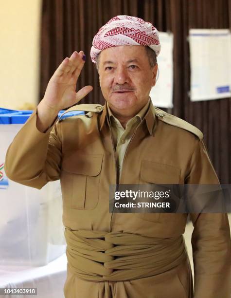Massud Barzani, leader of the Kurdistan Democratic Party , gestures after casting his ballot for the parliamentary election at a polling station in...