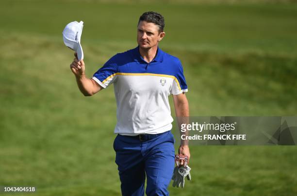 Europe's English golfer Justin Rose reacts during his singles match with US golfer Webb Simpson on the third day of the 42nd Ryder Cup at Le Golf...