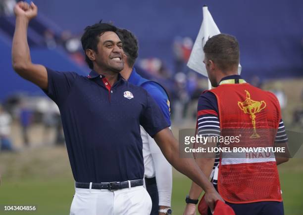 Golfer Tony Finau celebrates after winning his singles match with Europe's English golfer Tommy Fleetwood on the third day of the 42nd Ryder Cup at...