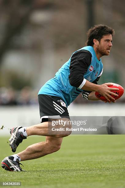 Paul Medhurst runs with the ball during a Collingwood Magpies AFL training session at Gosch's Paddock on September 22, 2010 in Melbourne, Australia.