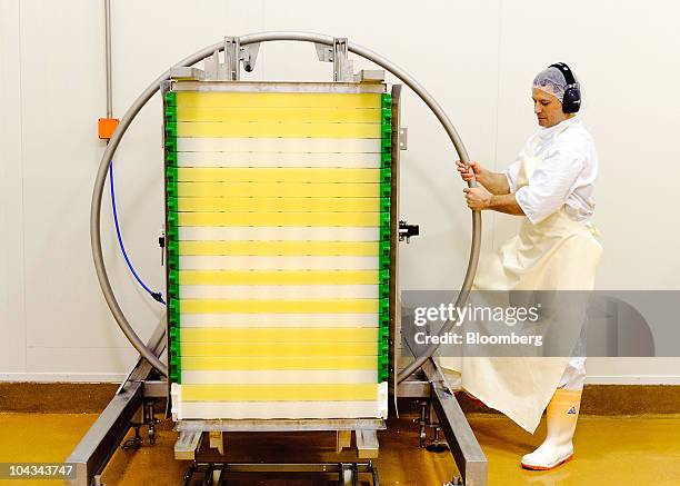 Employee Jason MacDonald turns camembert at Fonterra Cooperative Group Ltd.'s Fonterra Te Roto cheese factory in Paraparaumu, New Zealand, on...