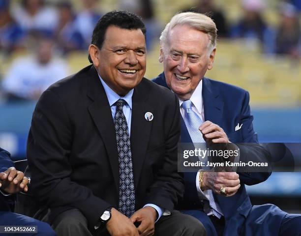 Retired Los Angeles Dodgers broadcaster Vin Scully, left, jokes with Spanish language broadcaster Fernando Valenzuela duirng a pregame ceremony...