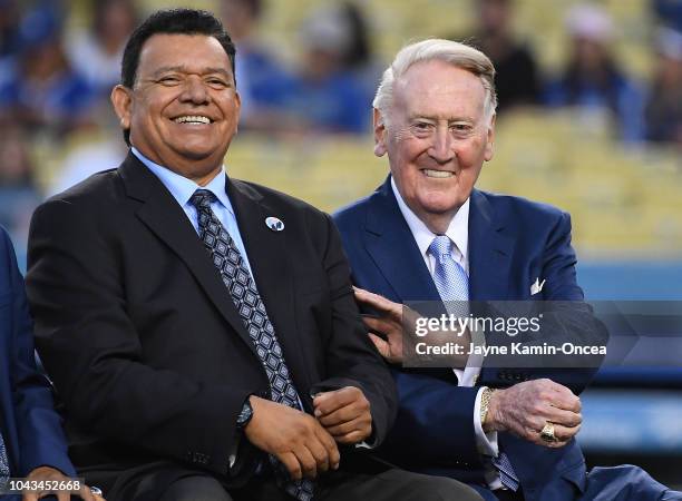 Retired Los Angeles Dodgers broadcaster Vin Scully, left, jokes with Spanish language broadcaster Fernando Valenzuela duirng a pregame ceremony...