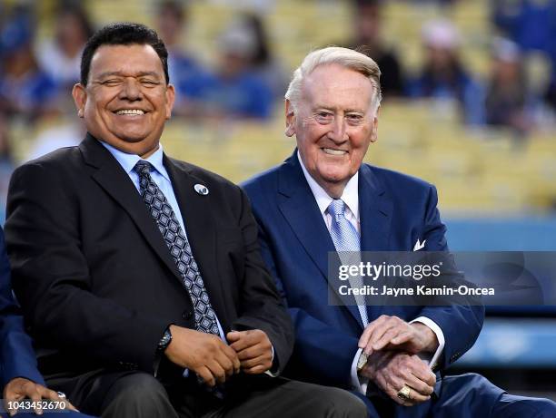 Retired Los Angeles Dodgers broadcaster Vin Scully, left, jokes with Spanish language broadcaster Fernando Valenzuela duirng a pregame ceremony...