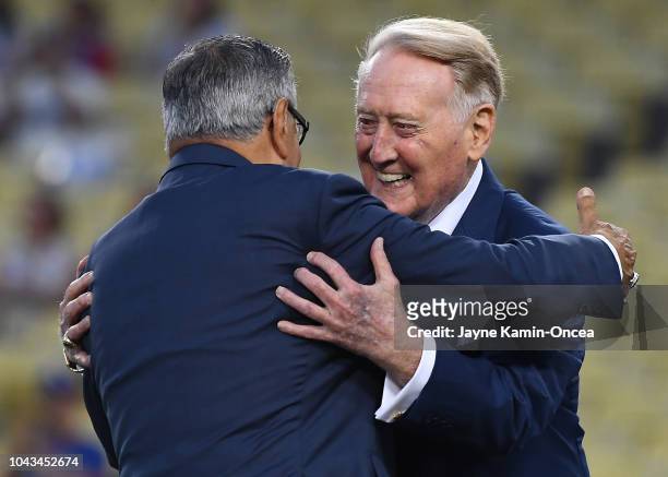 Retired Los Angeles Dodgers broadcaster Vin Scully, right, hugs Los Angeles Dodgers Spanish language broadcaster Jaime Jarrin during a pregame...
