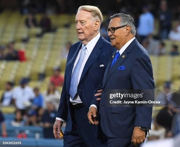 Retired Dodgers broadcaster Vin Scully, left, jokes with Dodgers Spanish language broadcaster Jaime Jarrin during a pregame ceremony inducting Jarrin...