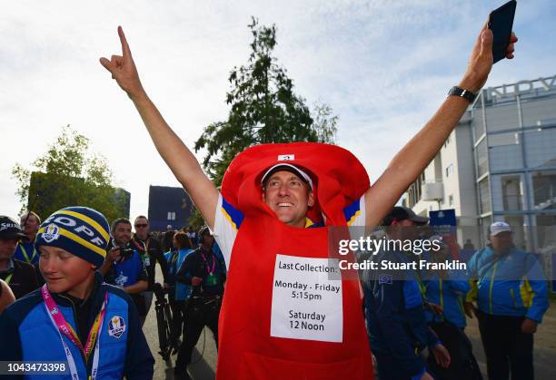 Ian Poulter of Europe celebrates winning The Ryder Cup after taking a Post Box outfitt off of a fan during singles matches of the 2018 Ryder Cup at...