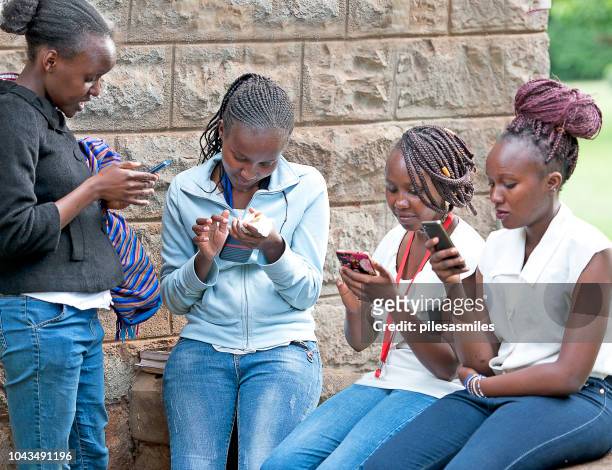 modern kenyan girls with mobile, nairobi, kenya, africa - nairobi kenya stock pictures, royalty-free photos & images