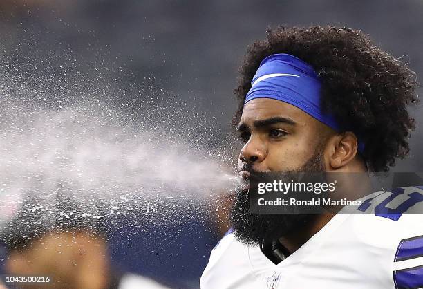 Ezekiel Elliott of the Dallas Cowboys spits water before a game against the Detroit Lions at AT&T Stadium on September 30, 2018 in Arlington, Texas.