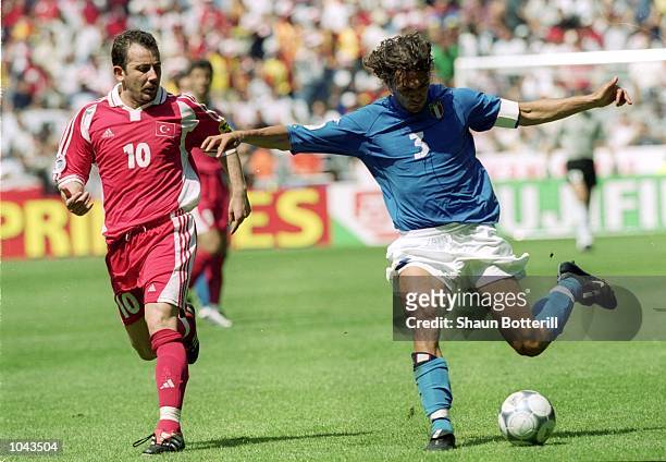 Paolo Maldini of Italy controls the ball ahead of Sergen Yalcin of Turkey during the European Championships 2000 Group B match at the Gelredome,...