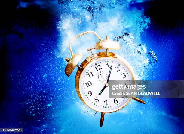 sinking alarm clock - creative08 stock pictures, royalty-free photos & images