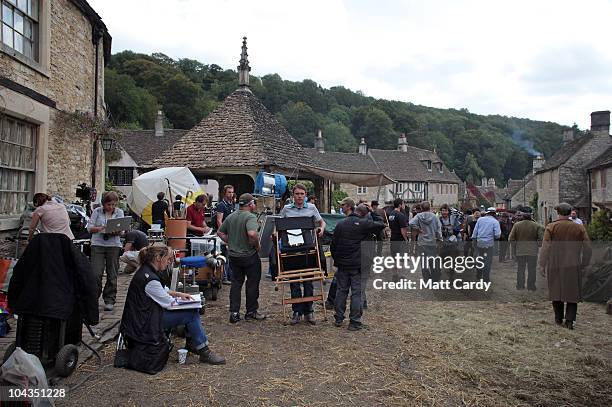 Film crew members wait for filming to continue on the set of 'War Horse' which is currently being filmed in Castle Combe on September 22, 2010 near...