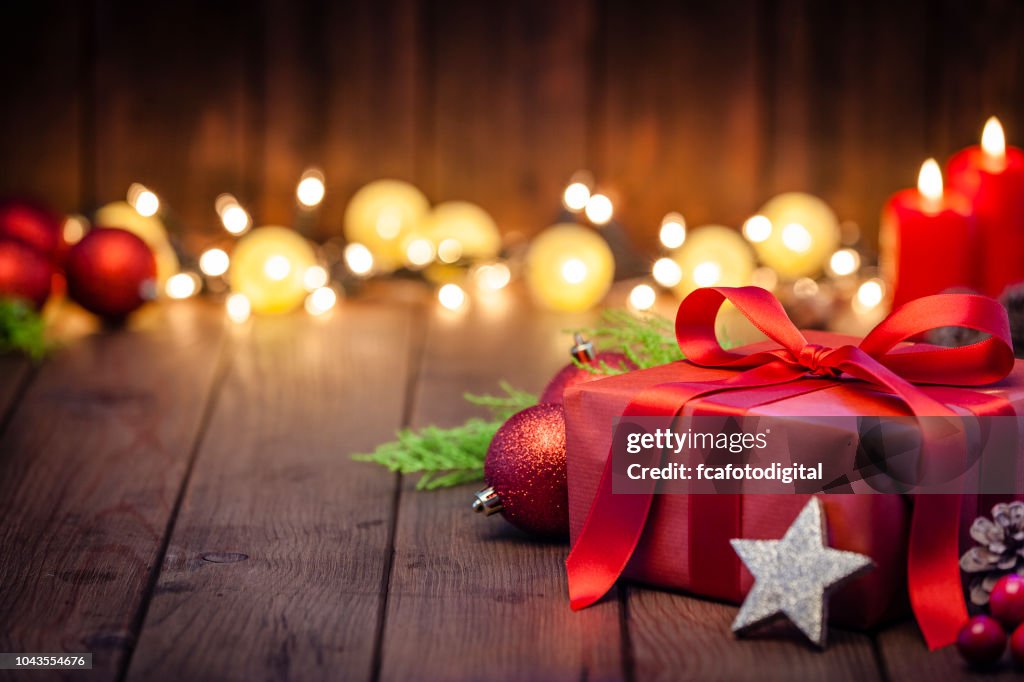 Red Christmas gift box on rustic wooden table