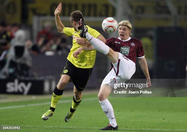 Jakub Blaszczykowski of Dortmund and Leon Jessen of Kaiserslautern battle for the ball during the Bundesliga match between Borussia Dortmund and 1....