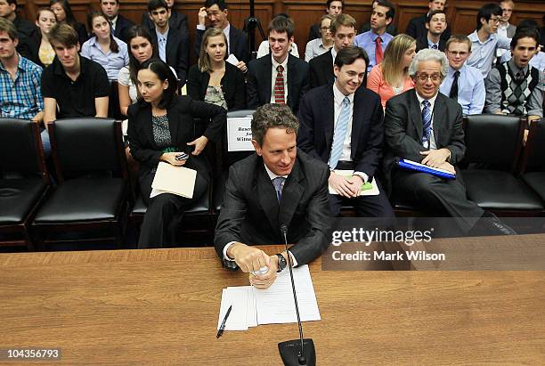 Treasury Secretary Timothy Geithner arrives at the witness table before the start of a House Financial Services Committee hearing on September 22,...