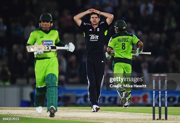 James Anderson of England holds his head as Kamran Akmal and Mohammad Hafeez of Pakistan run between the wickets during the 5th NatWest One Day...