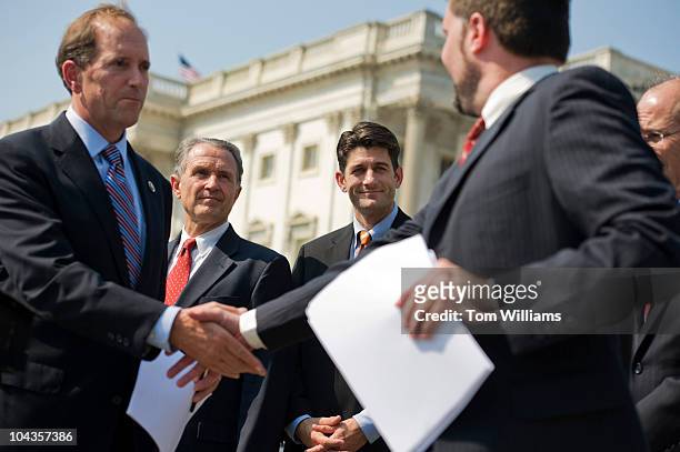 Rep. Dave Camp, R-Mich., left, greets Peter Sepp of the National Taxpayers Union , as Reps. Wally Herger, R-Calif., second from left, and Paul Ryan,...