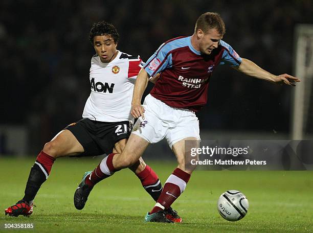 Rafael Da Silva of Manchester United clashes with Michael O'Connor of Scunthorpe United during the Carling Cup Third Round match between Scunthorpe...