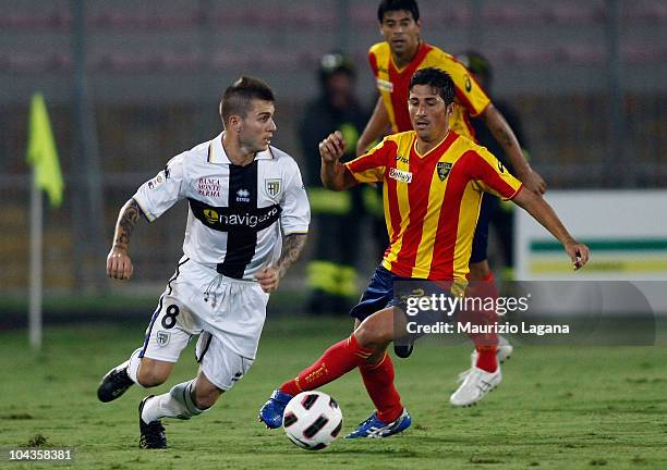 Fernando Marques of Parma FC is challenged by Giuseppe Vives of Lecce during the Serie A match between Lecce and Parma at Stadio Via del Mare on...