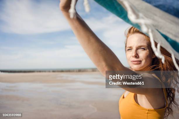 woman at the beach, holding swaying towel - swaying stock pictures, royalty-free photos & images
