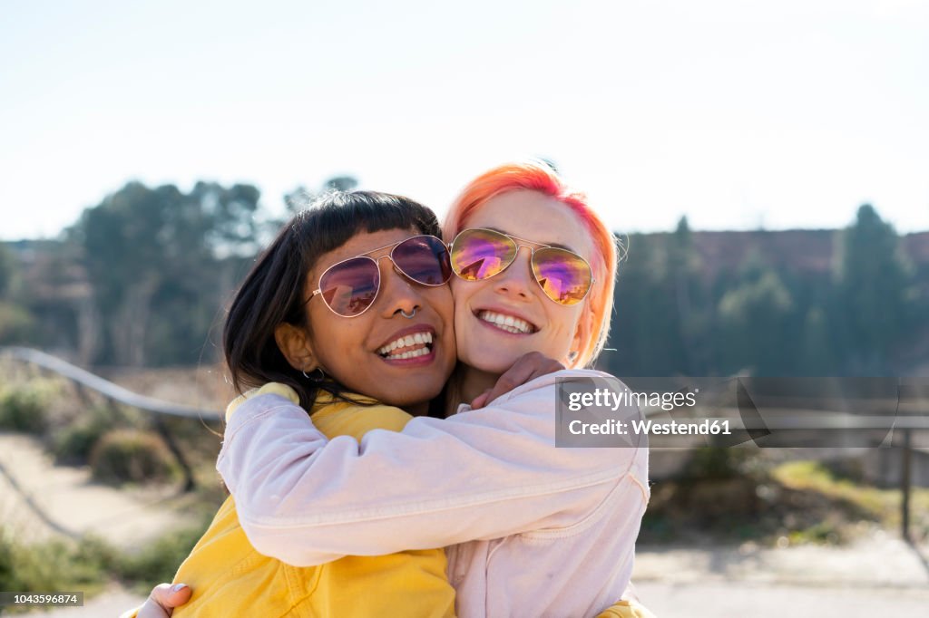 Portrait of two alternative friends embracing