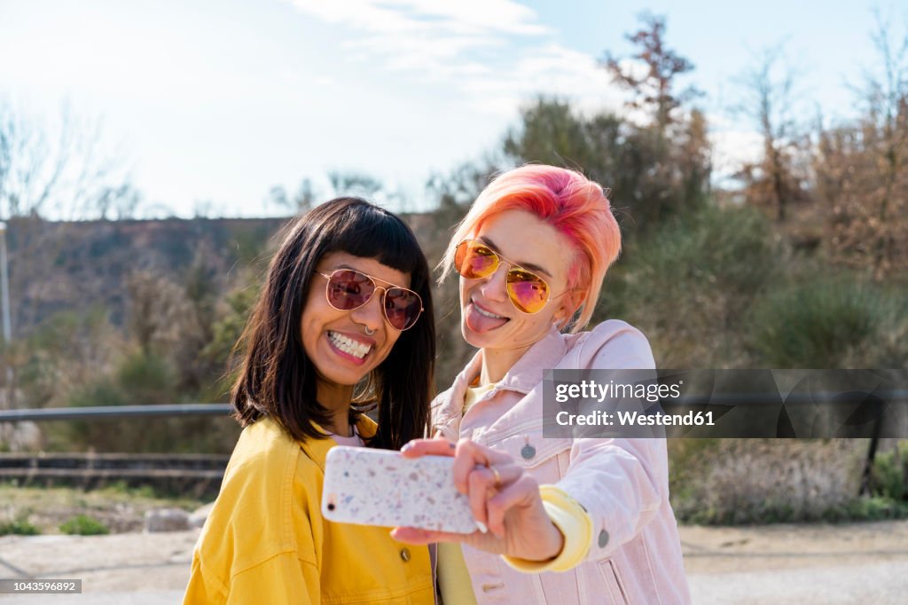 Two alternative friends taking selfie