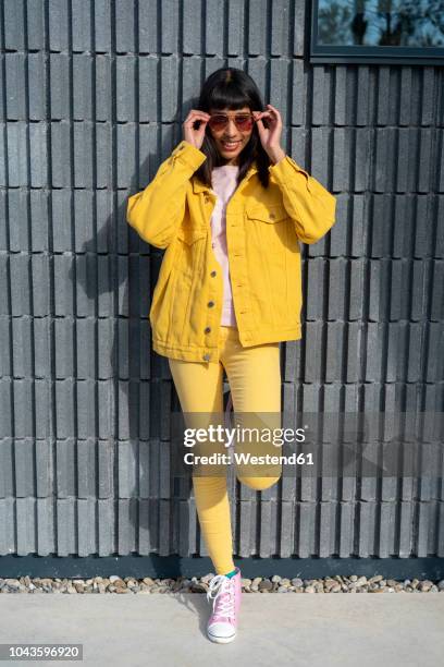 young woman wearing yellow jeans clothes - veste jaune photos et images de collection