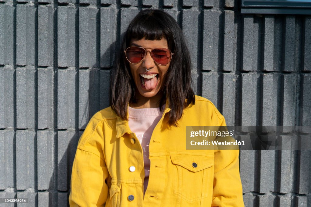 Portrait of young woman, wearing yellow jeans jacket