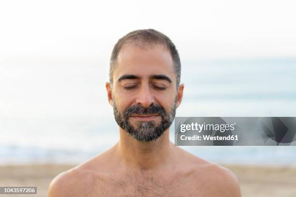 portrait of happy man on a beach in the evening - strand of human hair stock pictures, royalty-free photos & images