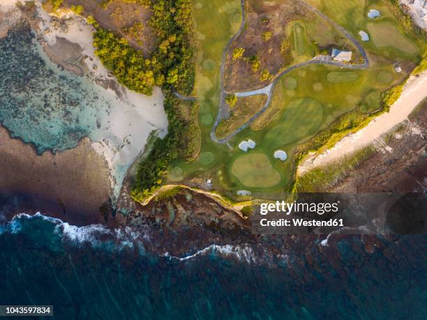 indonesia, bali, aerial view of golf course with bunker and green at coast - bali golf stock pictures, royalty-free photos & images