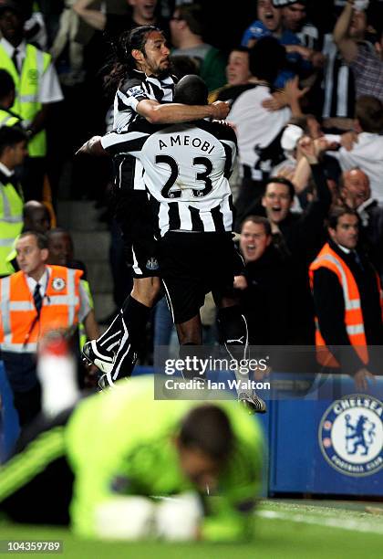 Shola Ameobi of Newcastle celebrates with teammate Jonas Gutierrez after scoring his team's fourth goal during the Carling Cup third round match...