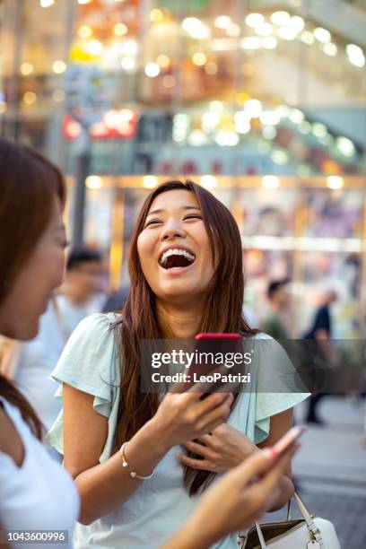 women friends in tokyo city streets, exploring and shopping in downtown - asia friend stock pictures, royalty-free photos & images