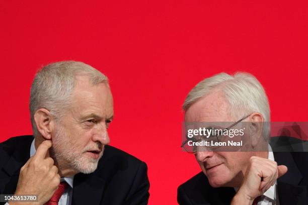 Labour Party leader Jeremy Corbyn sits with Shadow Chancellor of the Exchequer John McDonnell ahead of McDonnell's speech to delegates in the...