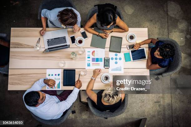 group of financial professionals analyzing markets - multi-cultural minority groups stock pictures, royalty-free photos & images