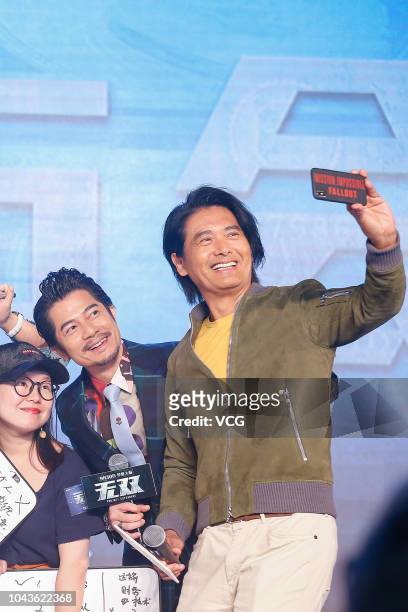 Actors Aaron Kwok Fu-shing and Chow Yun-fat take a selfie during the premiere of director Felix Chong Man-Keung's film 'Project Gutenberg' on...